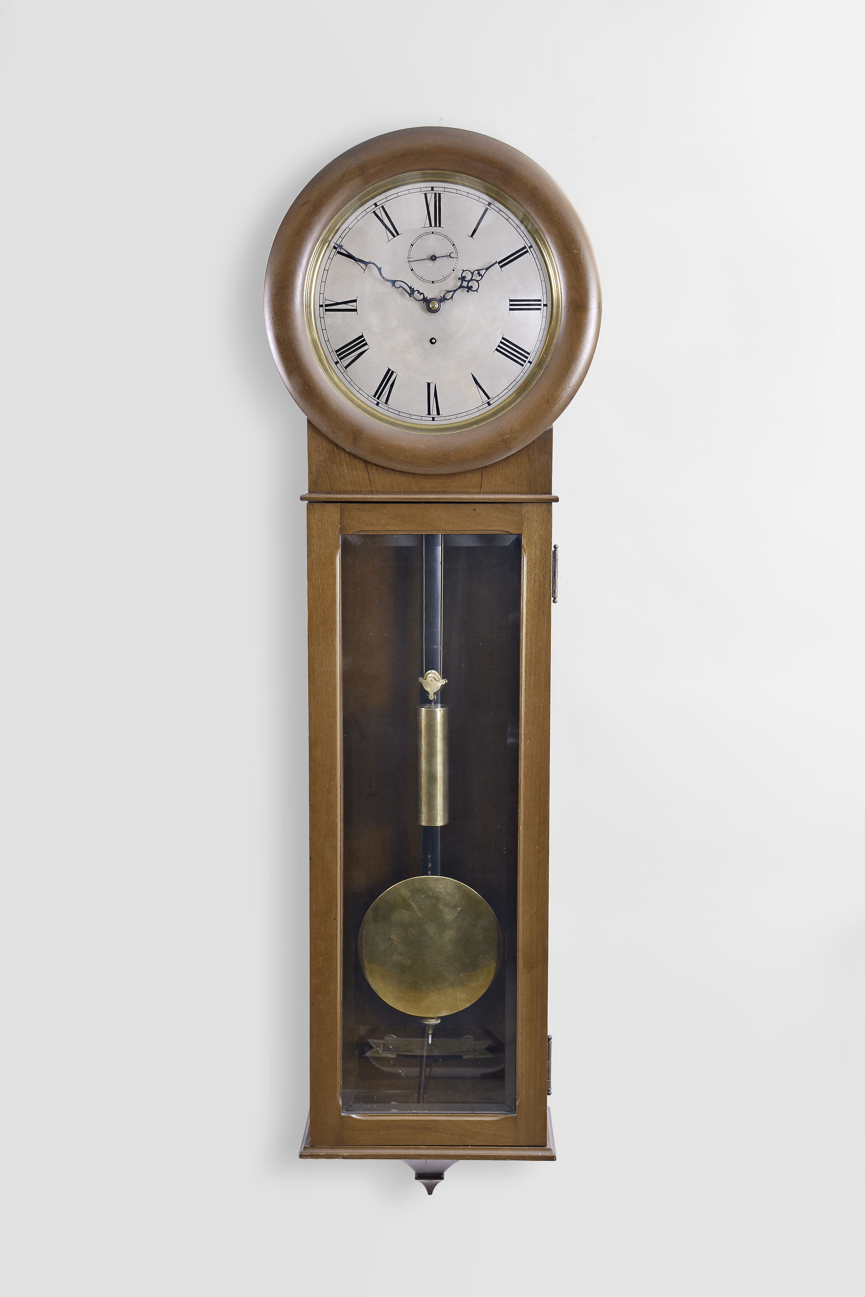 Seth Thomas Clock Co., Thomaston, Conn., "Regulator No. 62" wall clock, 8 day, time only, weight driven movement in a mahogany case with meter long pendulum, maintaining power and silvered dial — Antique Clocks Price Guide
