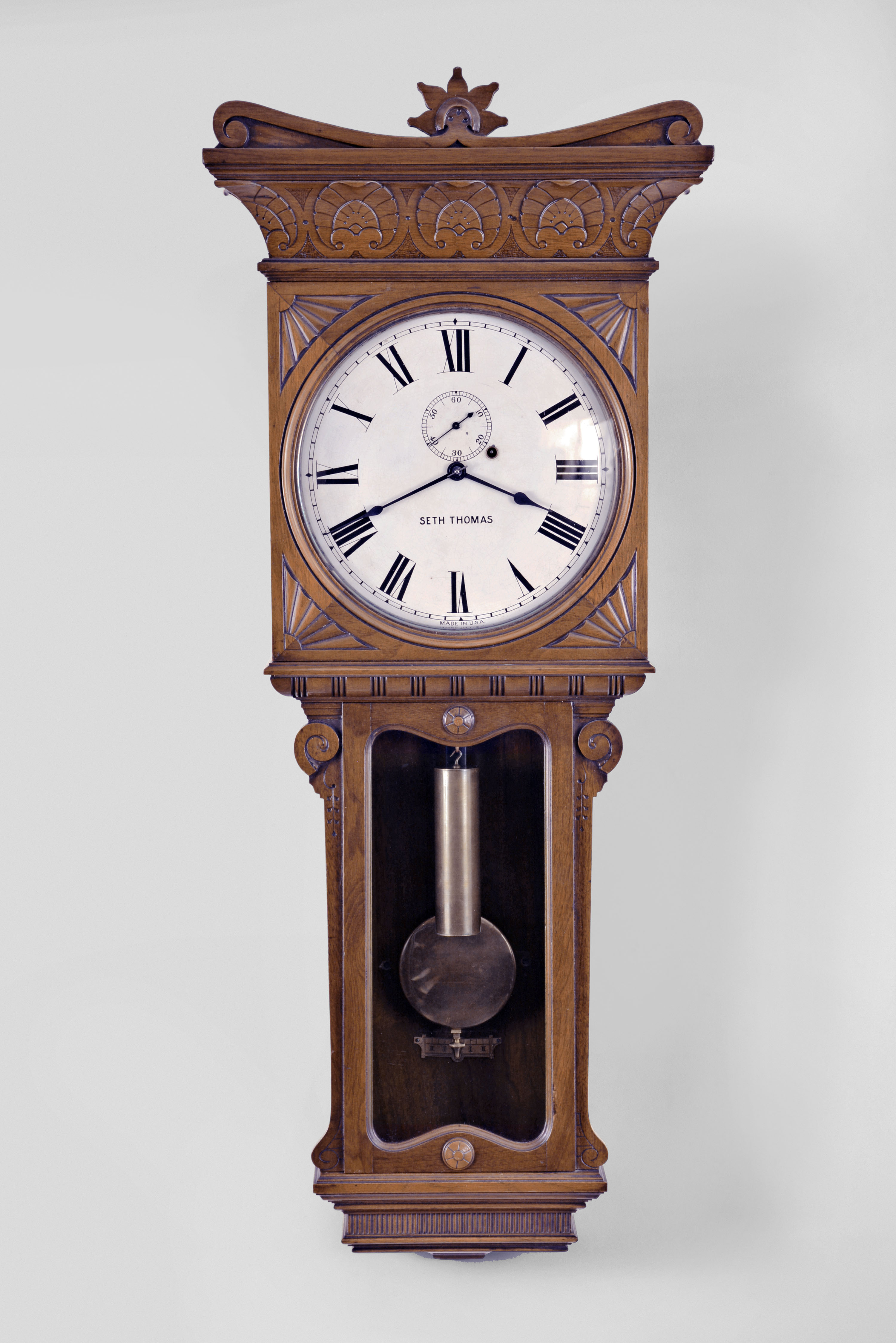 Seth Thomas Clock Co., Thomaston, Conn., "Regulator No. 7" wall hanging clock, spring driven 8 day timepiece movement with maintaining power in a walnut case. — Antique Clocks Price Guide