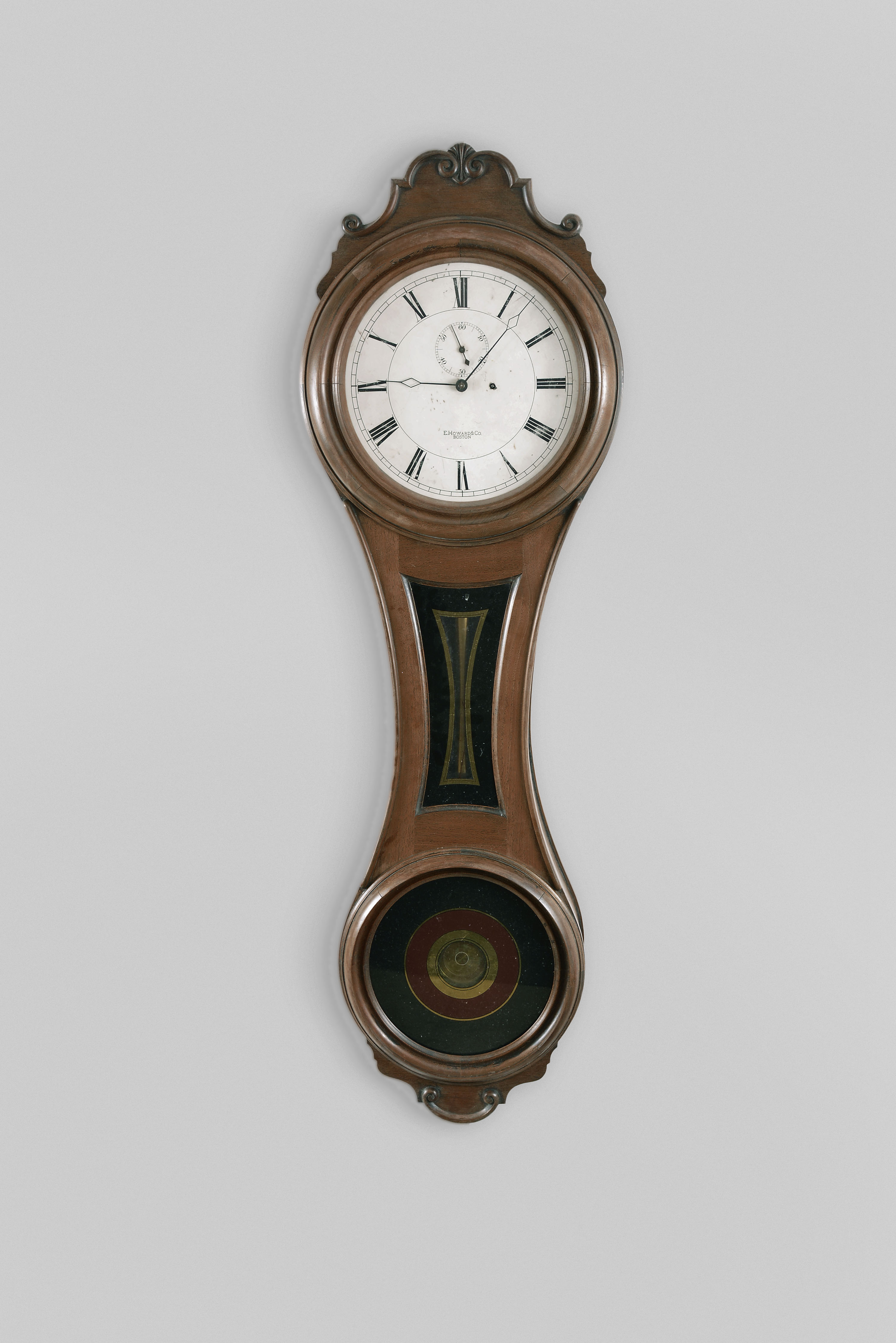 E. Howard & Co., Boston, Mass., "No. 6 Regulator", the largest figure eight wall clock, 8 day, time only, weight driven movement in a black walnut case with a painted metal dial, reverse painted tablets and damascened pendulum bob — Antique Clocks Price Guide