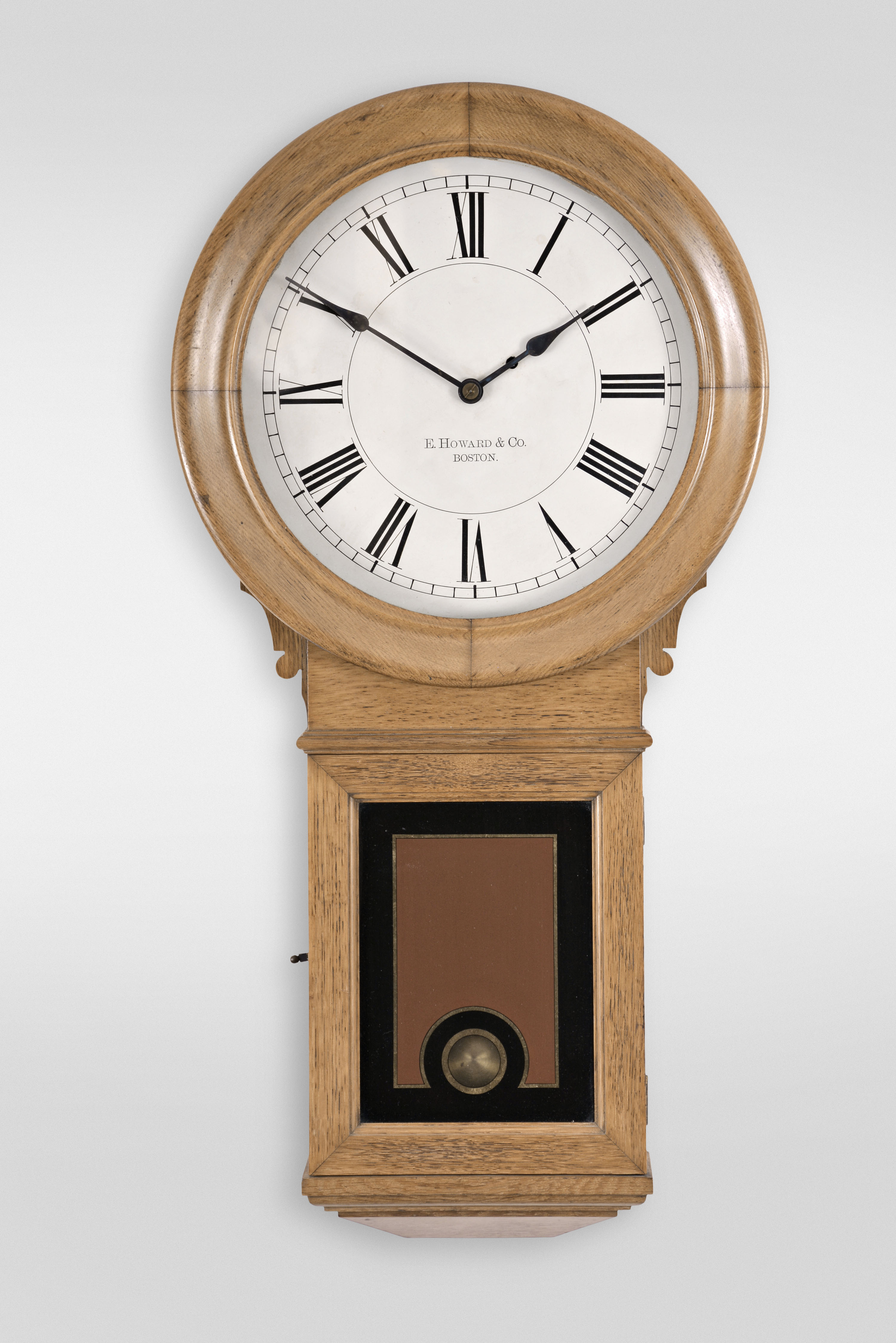 E. Howard & Co., Boston, Mass., "No. 70 Regulator, 14-Inch Dial" wall clock, 8 day, time only, weight driven wall clock in an oak case with painted metal dial and reverse painted lower tablet — Antique Clocks Price Guide