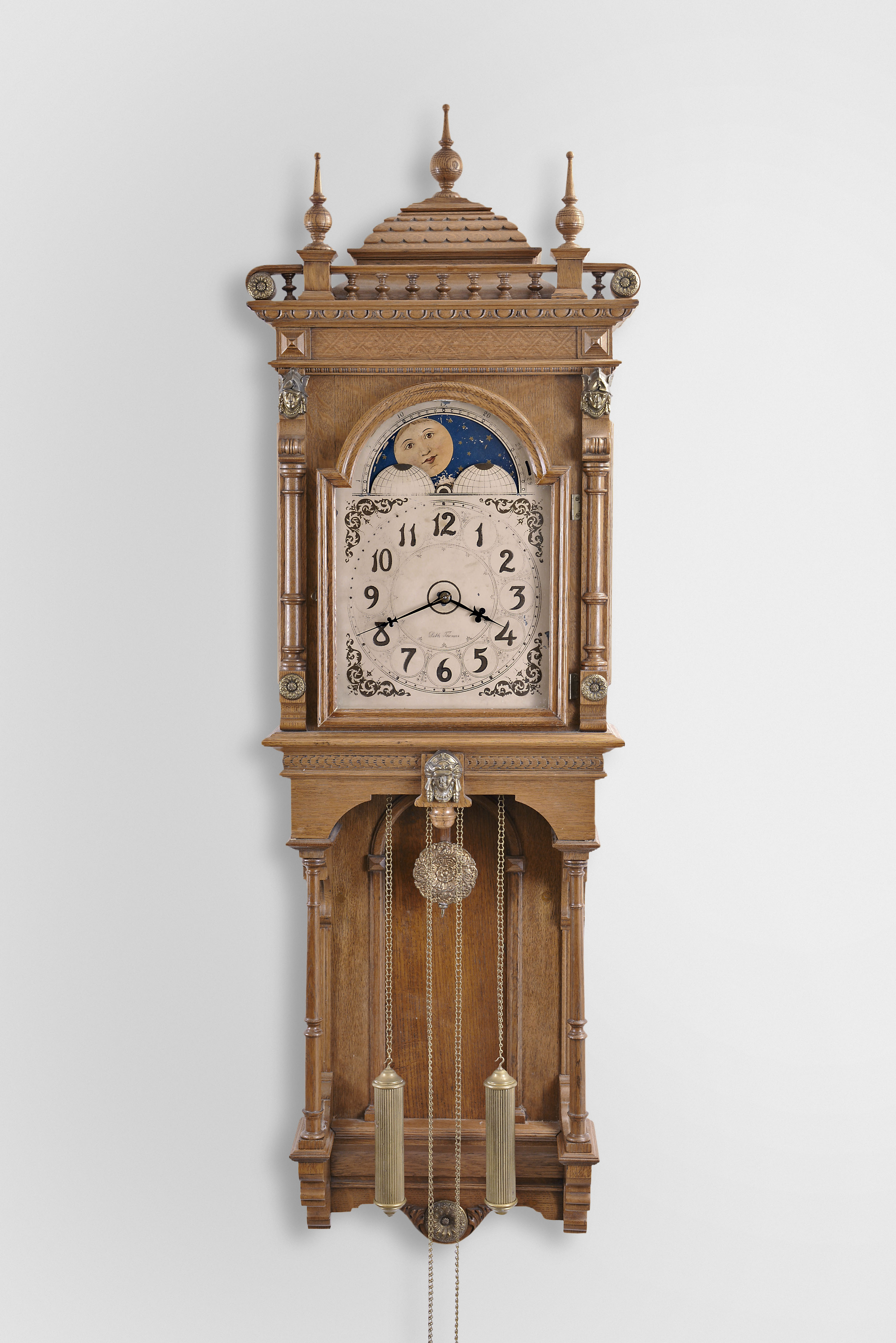 Seth Thomas Clock Co., Thomaston, Conn., "Jupiter" hanging clock with a weight driven 8 day time and strike (cathedral bell) lyre movement with a moon phase dial in an open well oak case. — Antique Clocks Price Guide