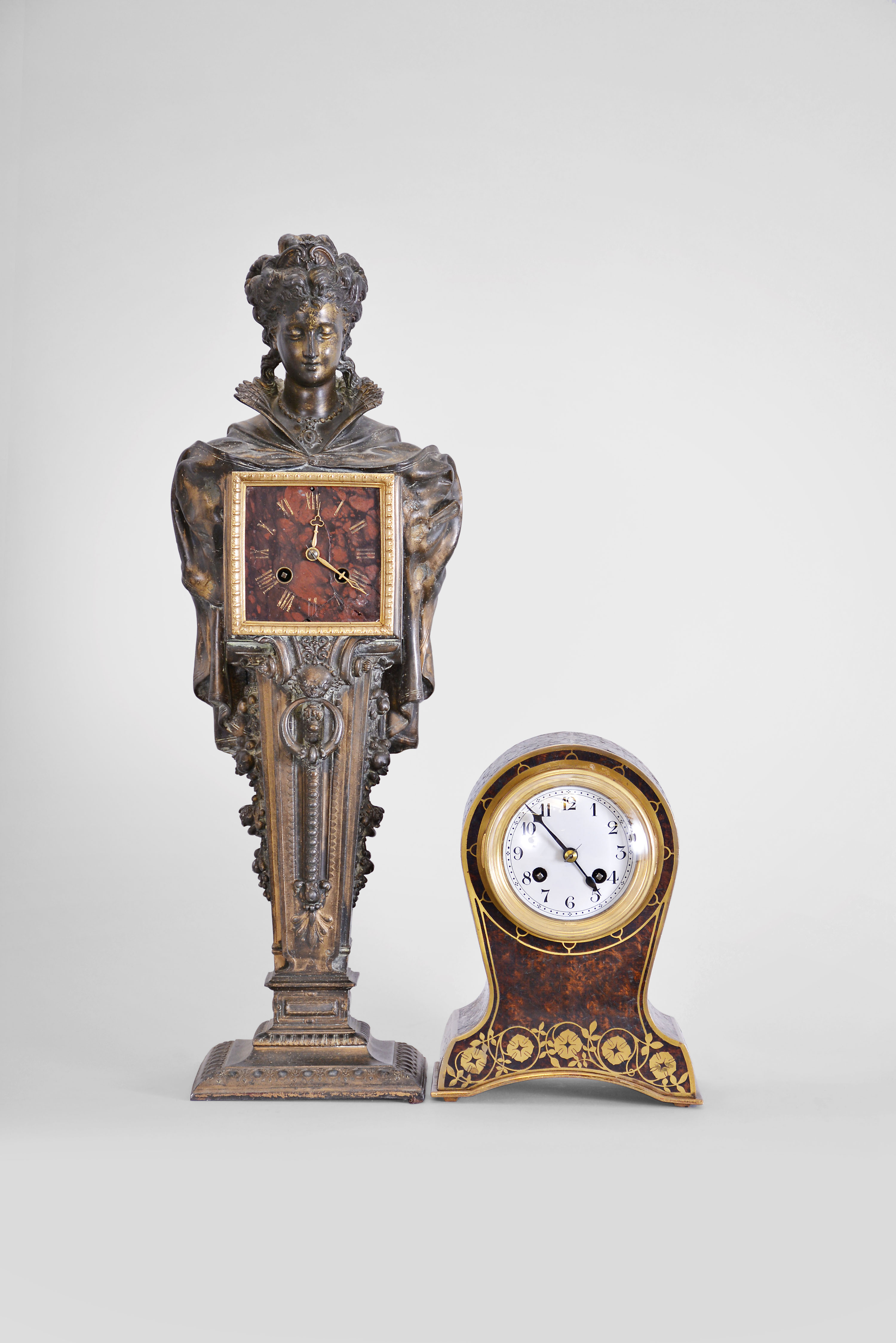 Clocks- 2 (Two): (1) French, Japy Freres, 8 day, time and strike spring brass movement figural clock. c1900 (2) French, 8 day, time and strike spring brass movement inlaid brass and burl walnut marquetry balloon style case. c1900 — Antique Clocks Price Guide