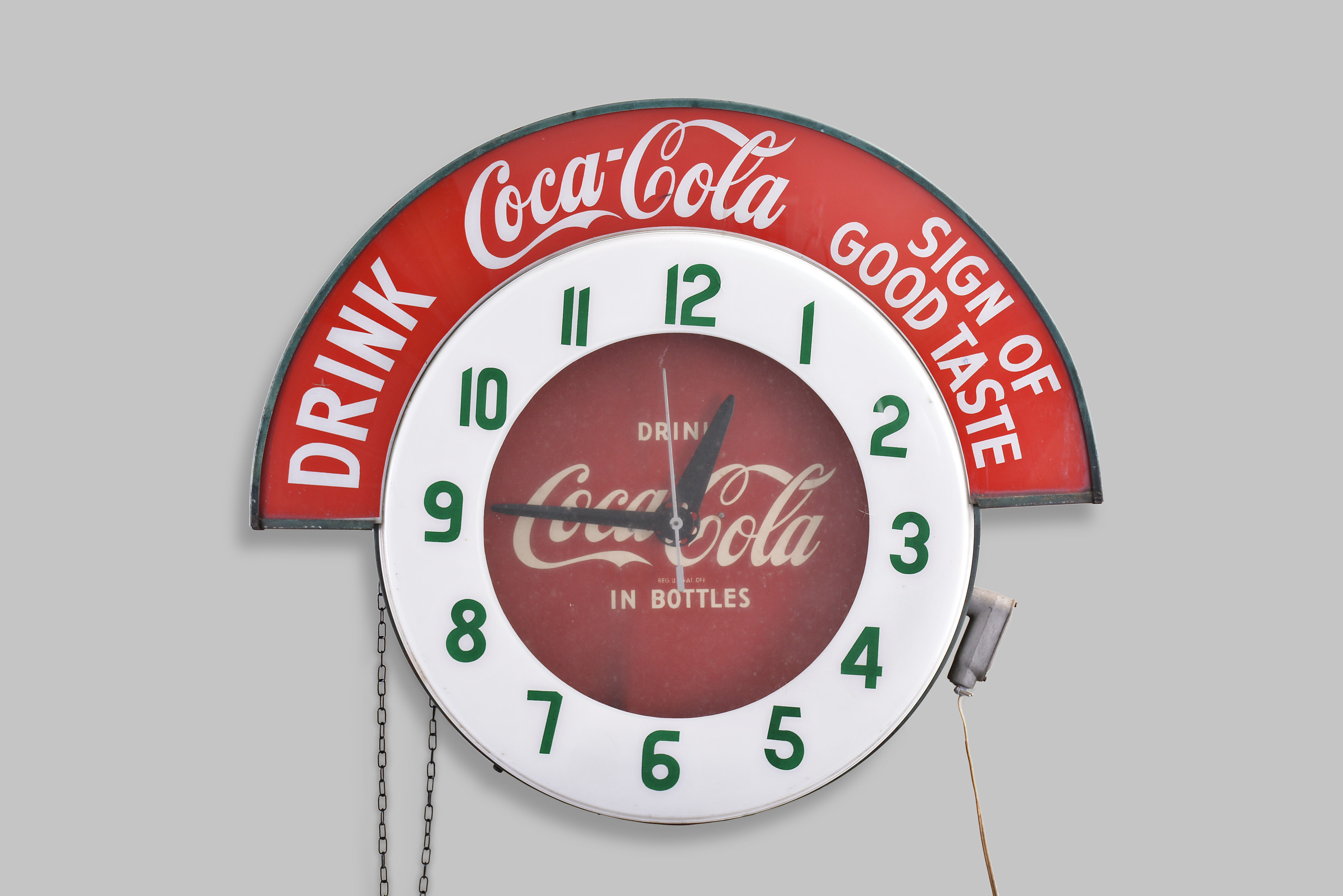 Clocks- 2 (Two) Coca Cola electric backlit advertising clocks: (1) Large period sign advertising "DRINK Coca Cola SIGN OF GOOD TASTE" with 24.5" plastic dial reading "DRINK IN BOTTLES "; (2) Small reproduction in 50's style — Antique Clocks Price Guide
