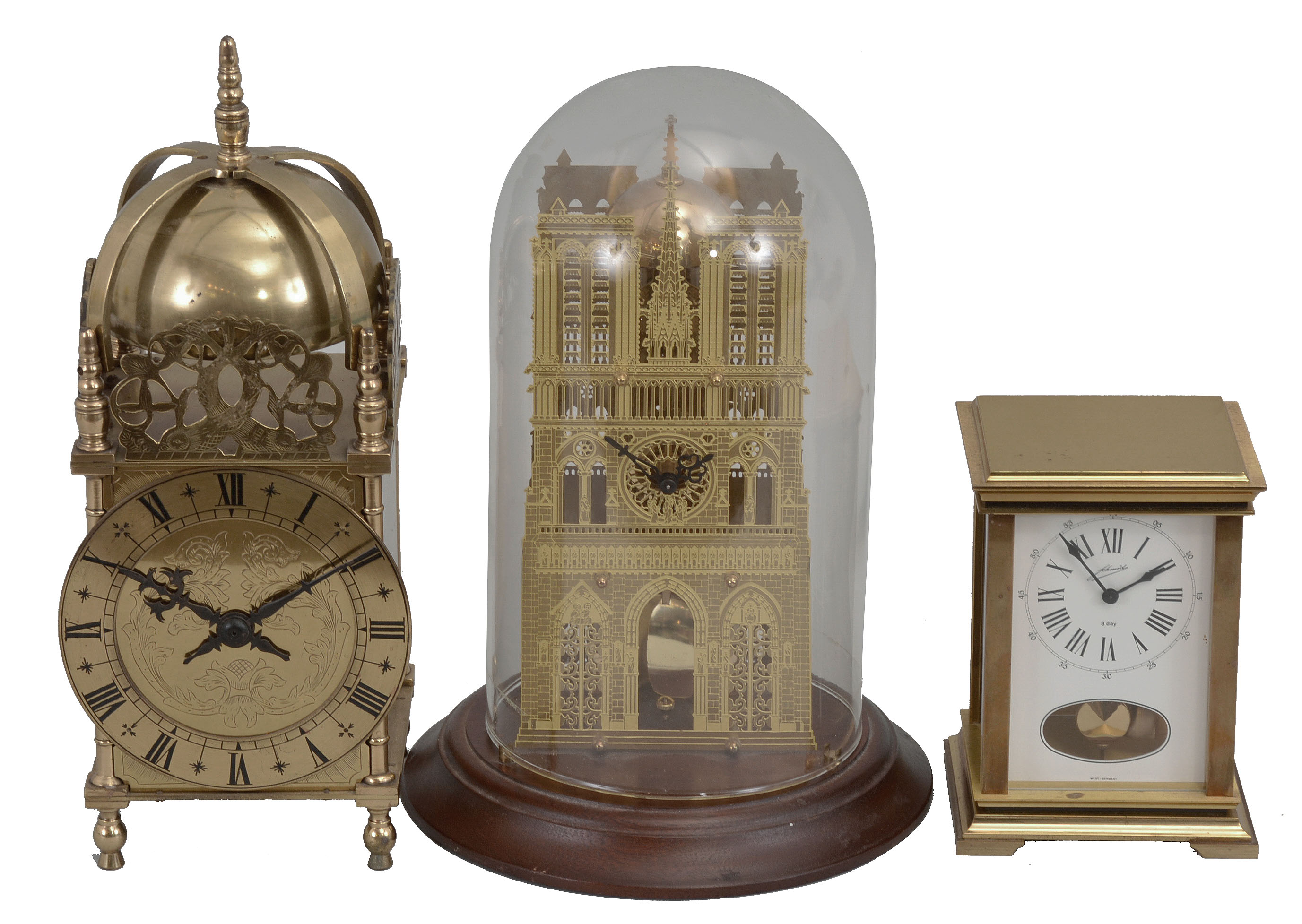 Clocks- 3 (Three): (1) All British Escapement Co., London, lantern clock reproduction, 8 day, time only, spring driven balance wheel movement with lever escapement in a brass case, c1940; (2) Hermle, Gosheim, Germany, skeleton style clock, 8 day, time and passing strike, spring driven movement in a pierced brass case under a glass dome, c1989 (3) W.& A. Schmid,Schwenningen, Germany, carriage style clock, 8 day, time and strike, spring driven pendulum movement in a brass and glass case, c1985. — Antique Clocks Price Guide
