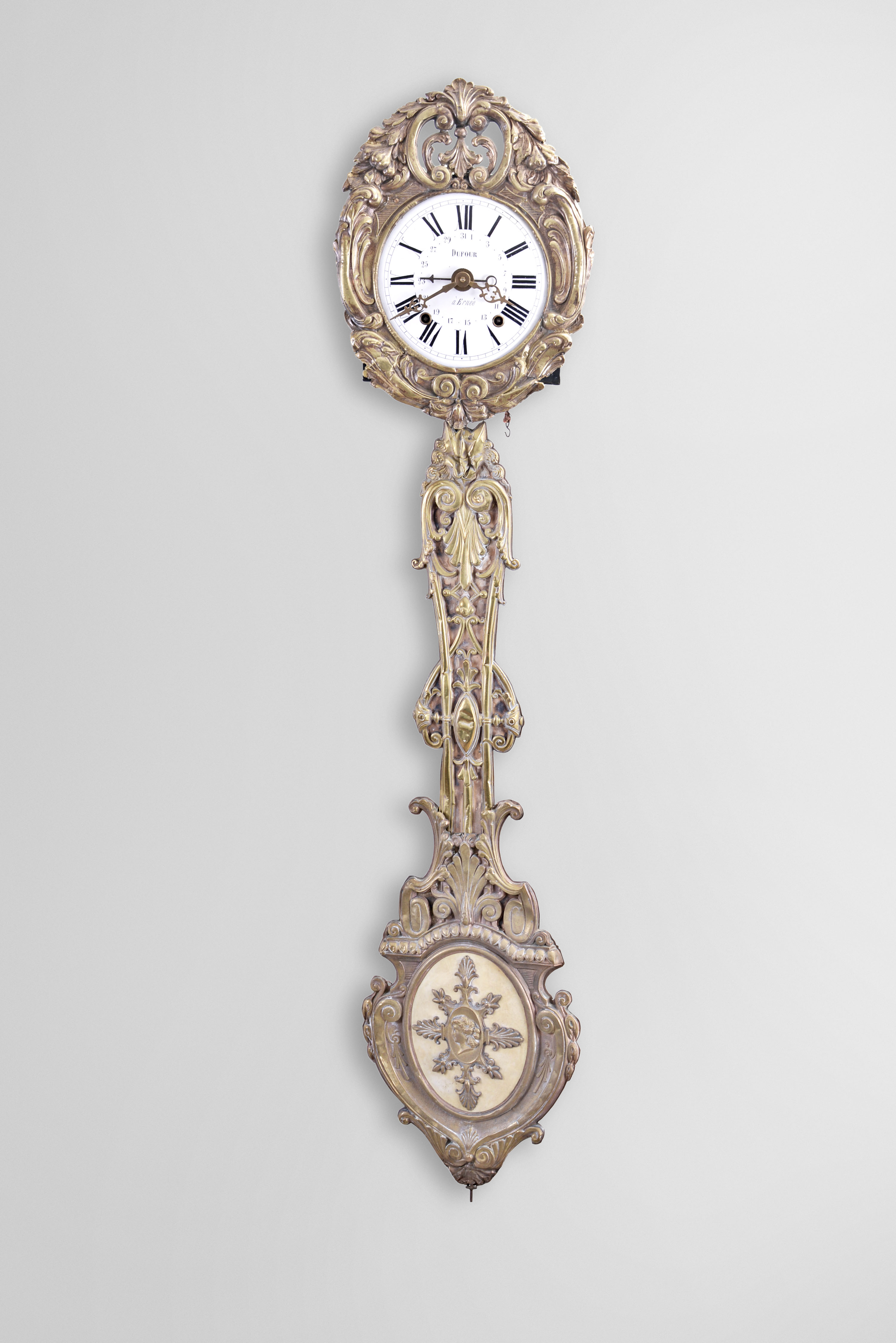 France, Morbier or Comtoise clock, 8 day, time and strike with simple calendar, weight driven movement with anchor escapement in an iron post and plate frame, convex white enamel dial with Roman numerals signed "Dufour Ernee", press brass fronton and matching pendulum with scroll design, two pierced brass hands an one iron hand. — Antique Clocks Price Guide