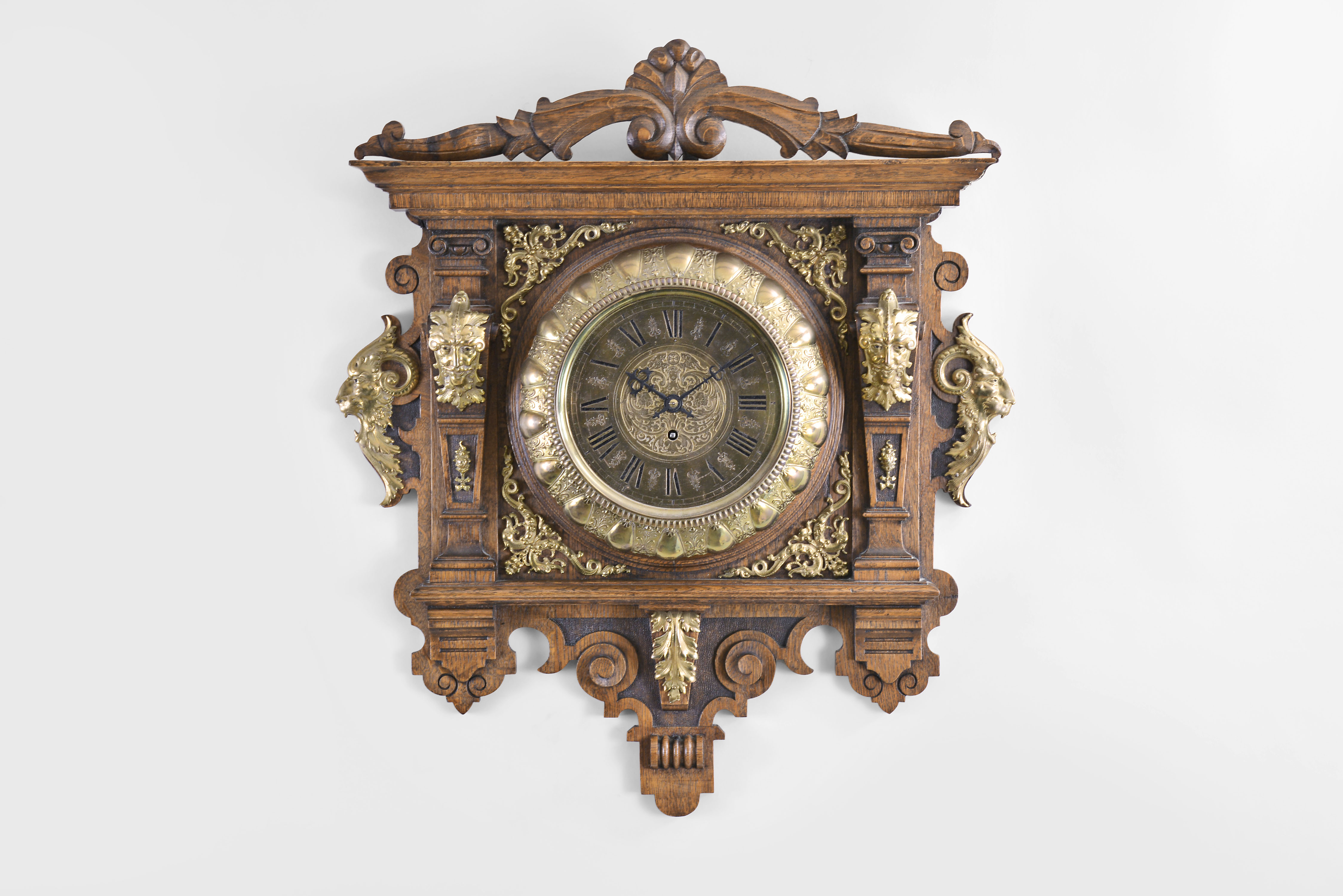 Lenzkirch Clock Co., Germany, wall clock, 8 day, time only, spring driven movement in a fancy oak case with applied brass accoutrements, brass housing for clock and carved crest, brass dial, and cut steel hands, serial #41323 — Antique Clocks Price Guide