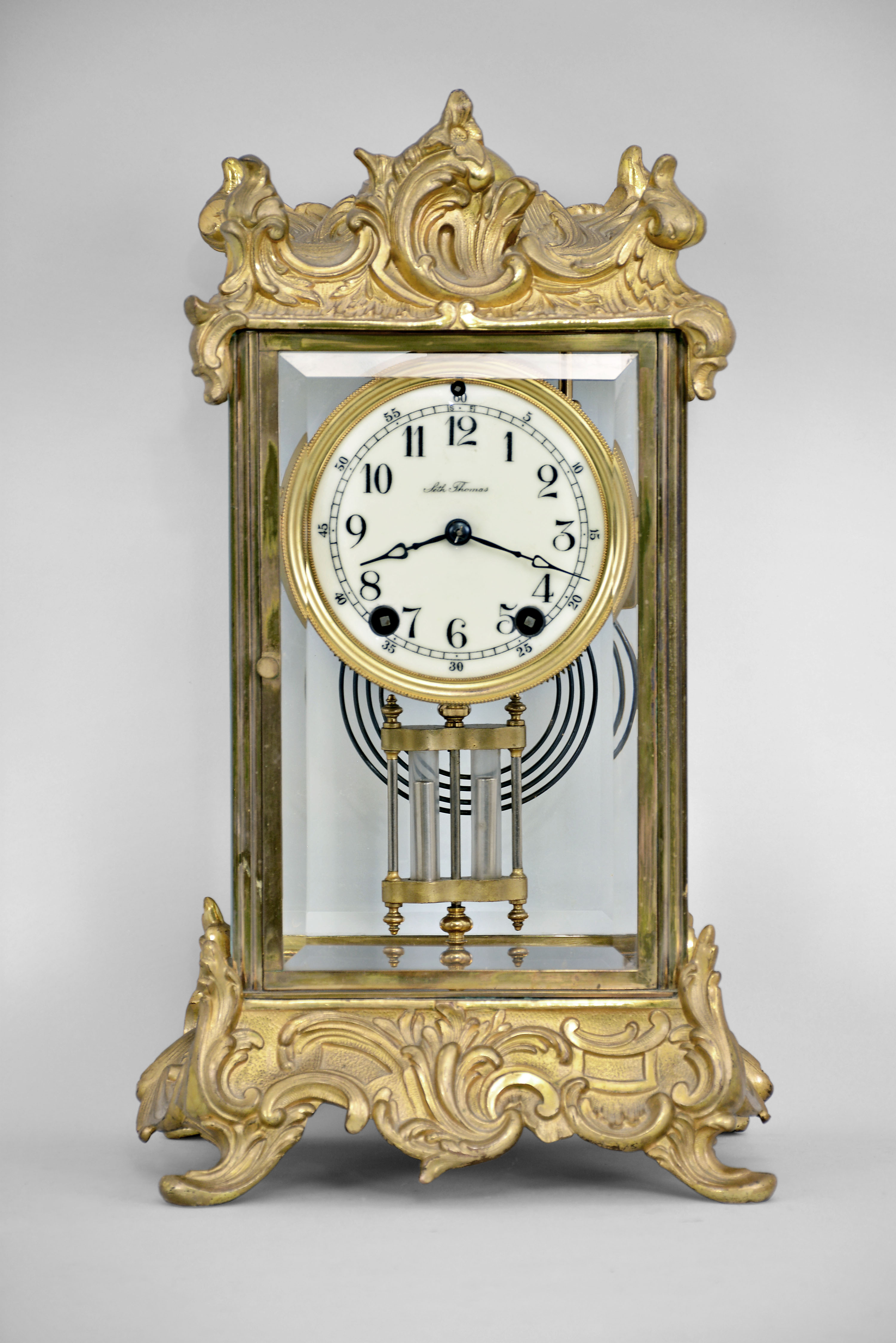 Seth Thomas Clock Co., Thomaston, Conn,, "Empire No. 10" crystal regulator with a spring driven 8 day time and half hour strike movement in a polished metal case, gilded and laquered. — Antique Clocks Price Guide