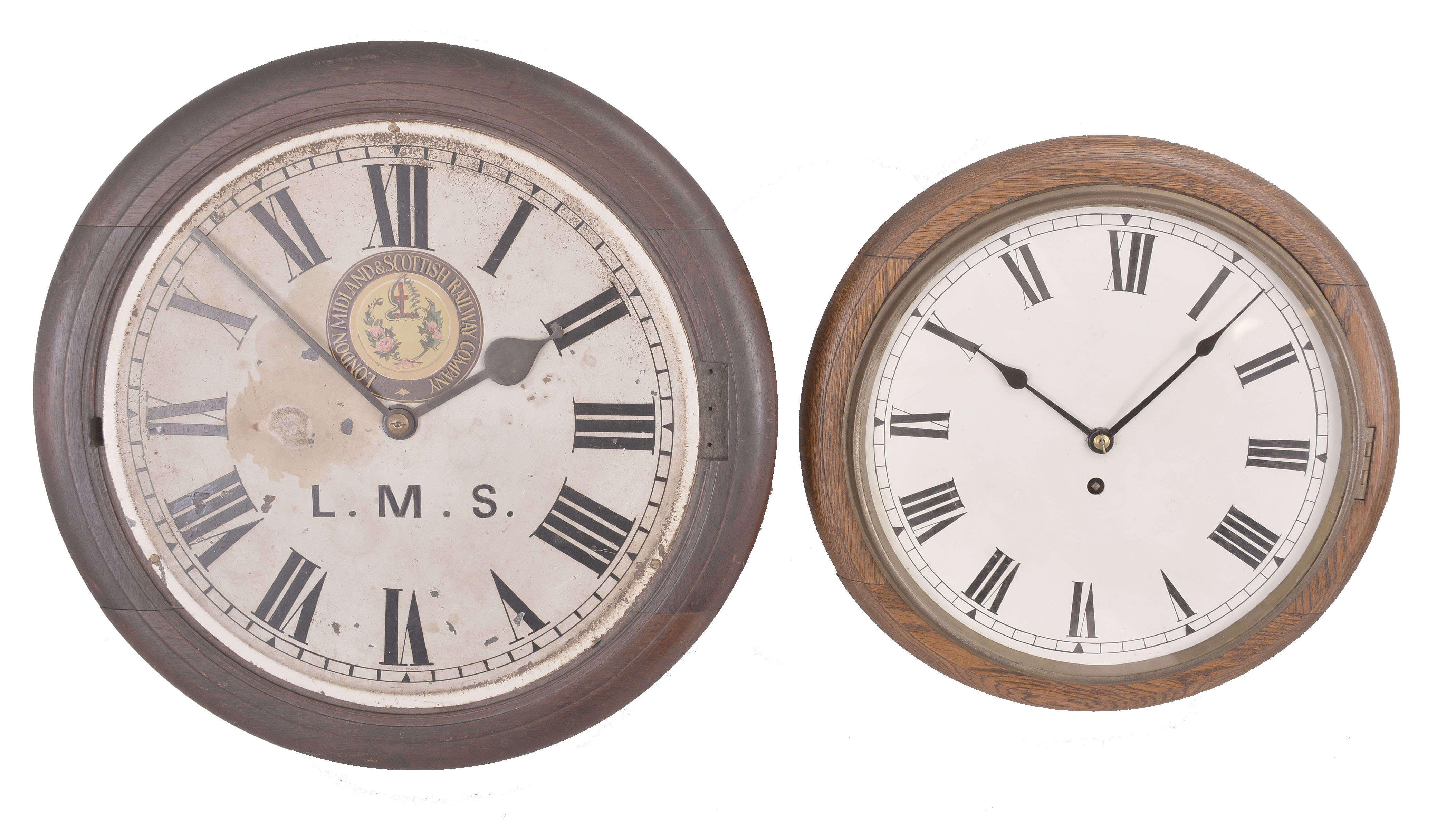 Clocks- 2 (Two) English Dial Clocks: (1) Coventry / Astral, England, dial clock, 8 day, time only, spring driven fusee movement in a walnut case with painted metal dial featuring the seal of the "London Midland & Scottish Railway Company", c1925; (2) England, dial clock, 8 day, spring driven fusee movement in a wood case with oak bezel, painted metal dial, c1915. — Antique Clocks Price Guide