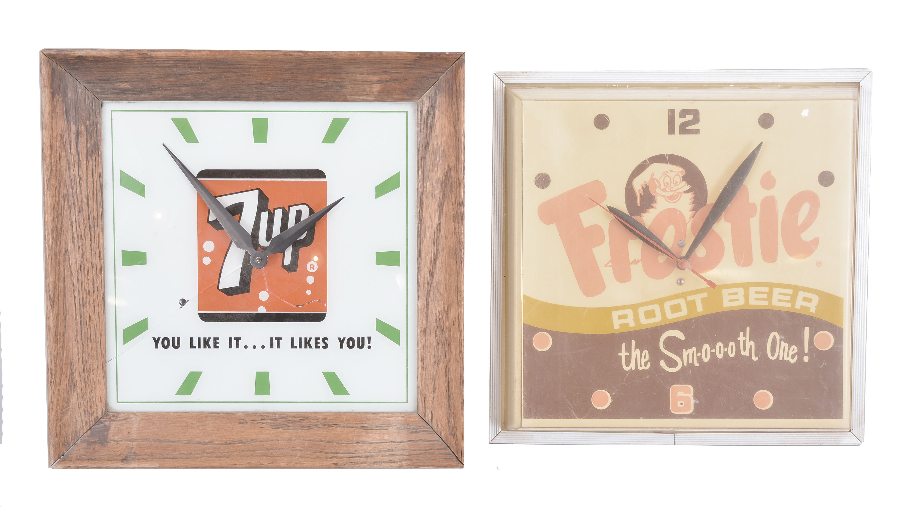 Clocks- 4 (Four) Plug-in Electric Advertising: (1) 7-Up wall clock with back-painted glass dial and wood frame, internal light with logo and the words "You Like It...It Likes You! "; (2) Genesee Beer & Ale wall clock with sweep seconds and internal illumination; (3) Frostie Root Beer clock with sweep seconds, dial with Frostie logo and tagline reading "The Smooth One! "; (4) Hires Draft Style Root Beer clock with internal illumination. — Antique Clocks Price Guide