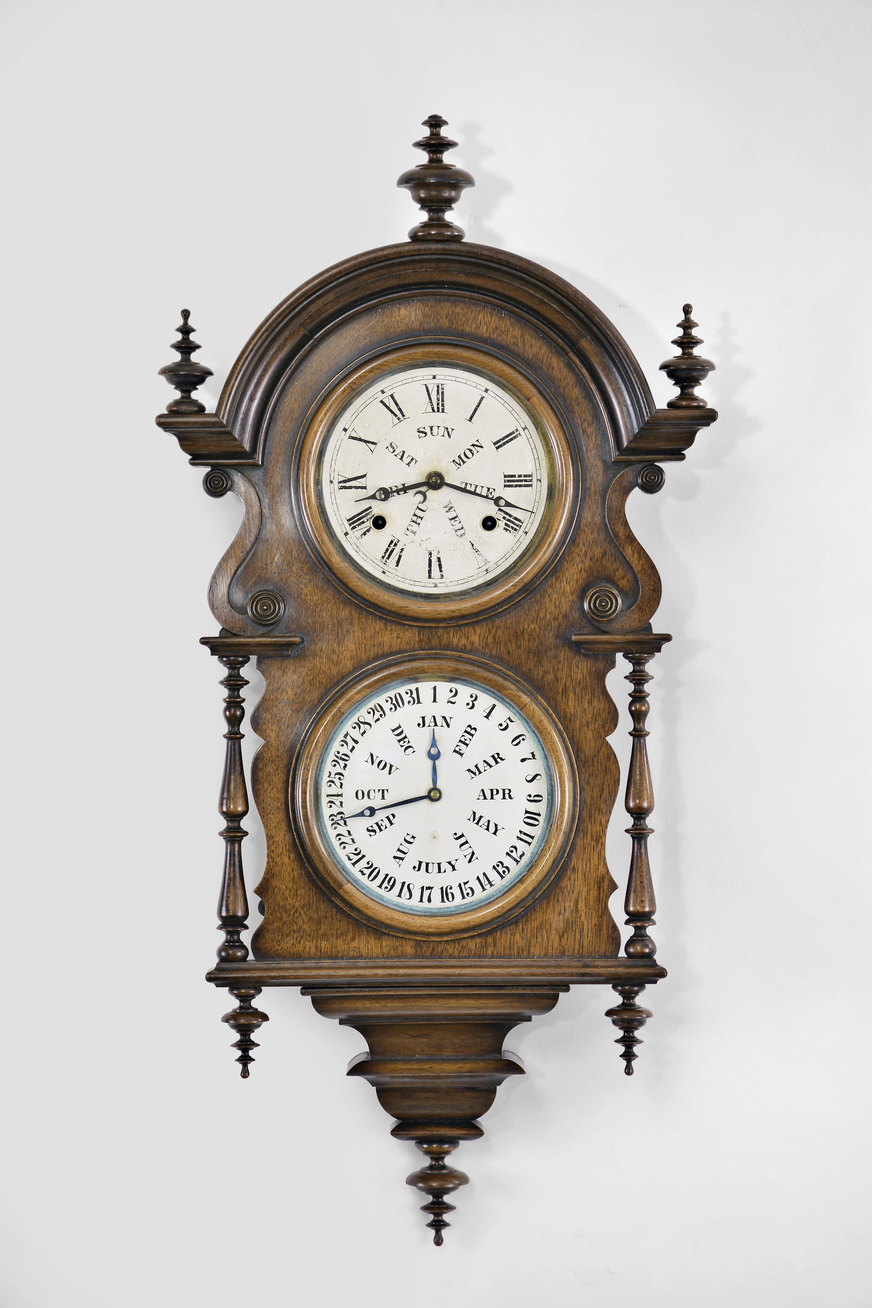 Welch, Spring, & Co., Forestville, Conn., "Wagner" hanging calendar clock with a spring driven 8 day time and strike movement and a B. B. Lewis patented perpetual calendar mechanism in a walnut case. — Antique Clocks Price Guide