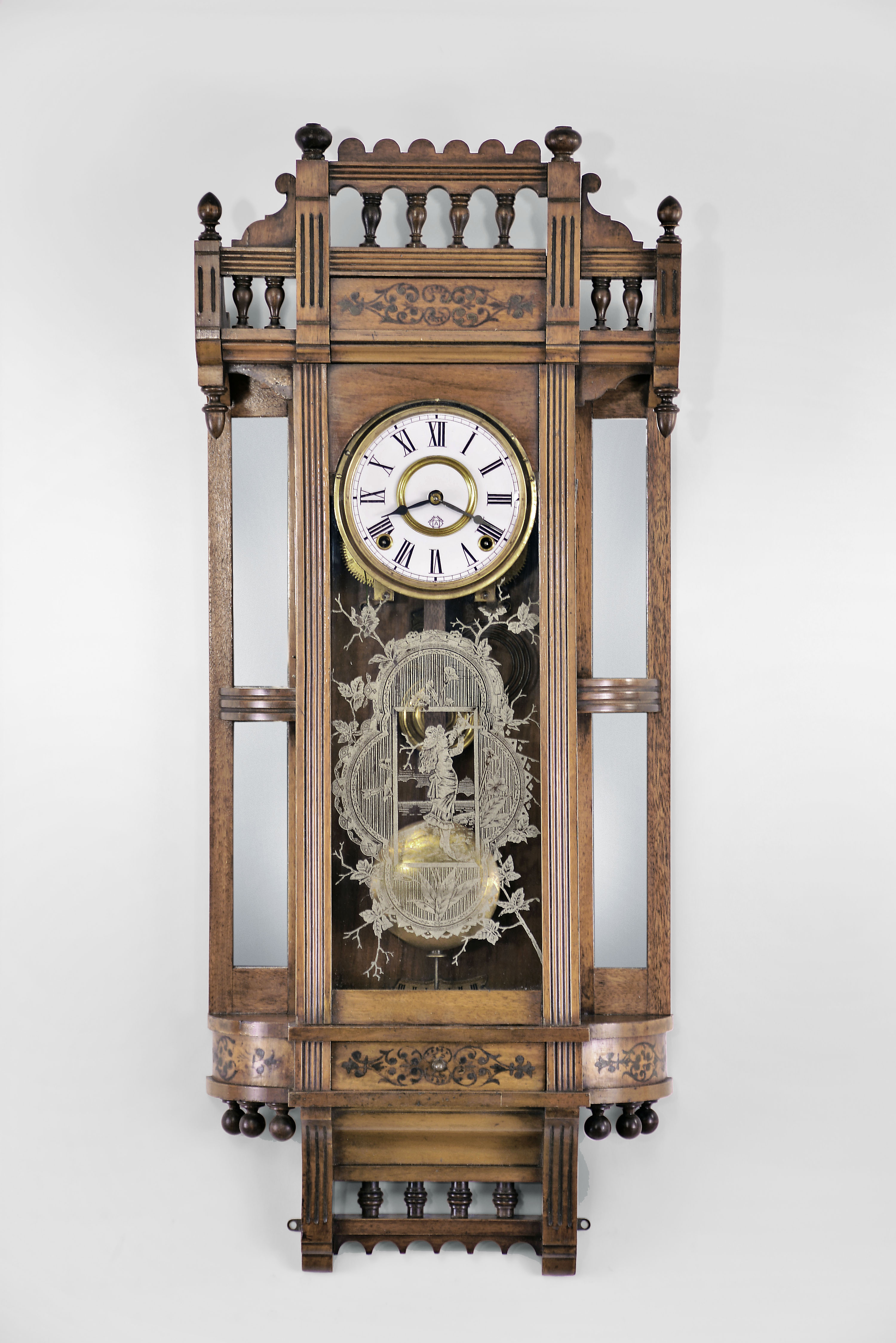 Ansonia Clock Co., New York, "Reflector" wall hanging clock with a spring driven 8 day time and strike (cathedral gong) movement in a walnut case. — Antique Clocks Price Guide