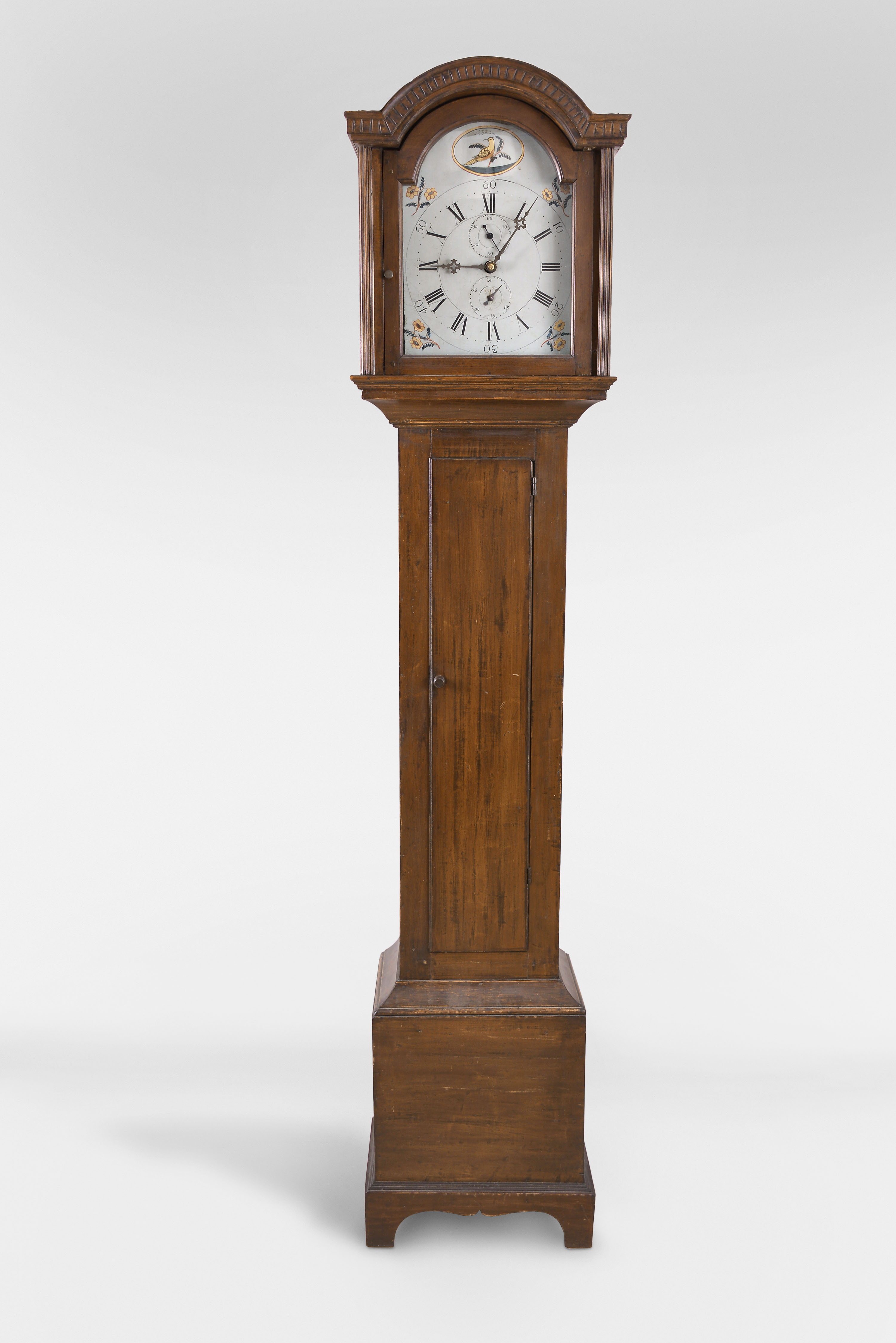 Connecticut Tall Clock, 30 hour, time and strike, weight driven wooden works movement in a soft wood case with mahogany finish and painted wooden dial with calendar and seconds bit — Antique Clocks Price Guide