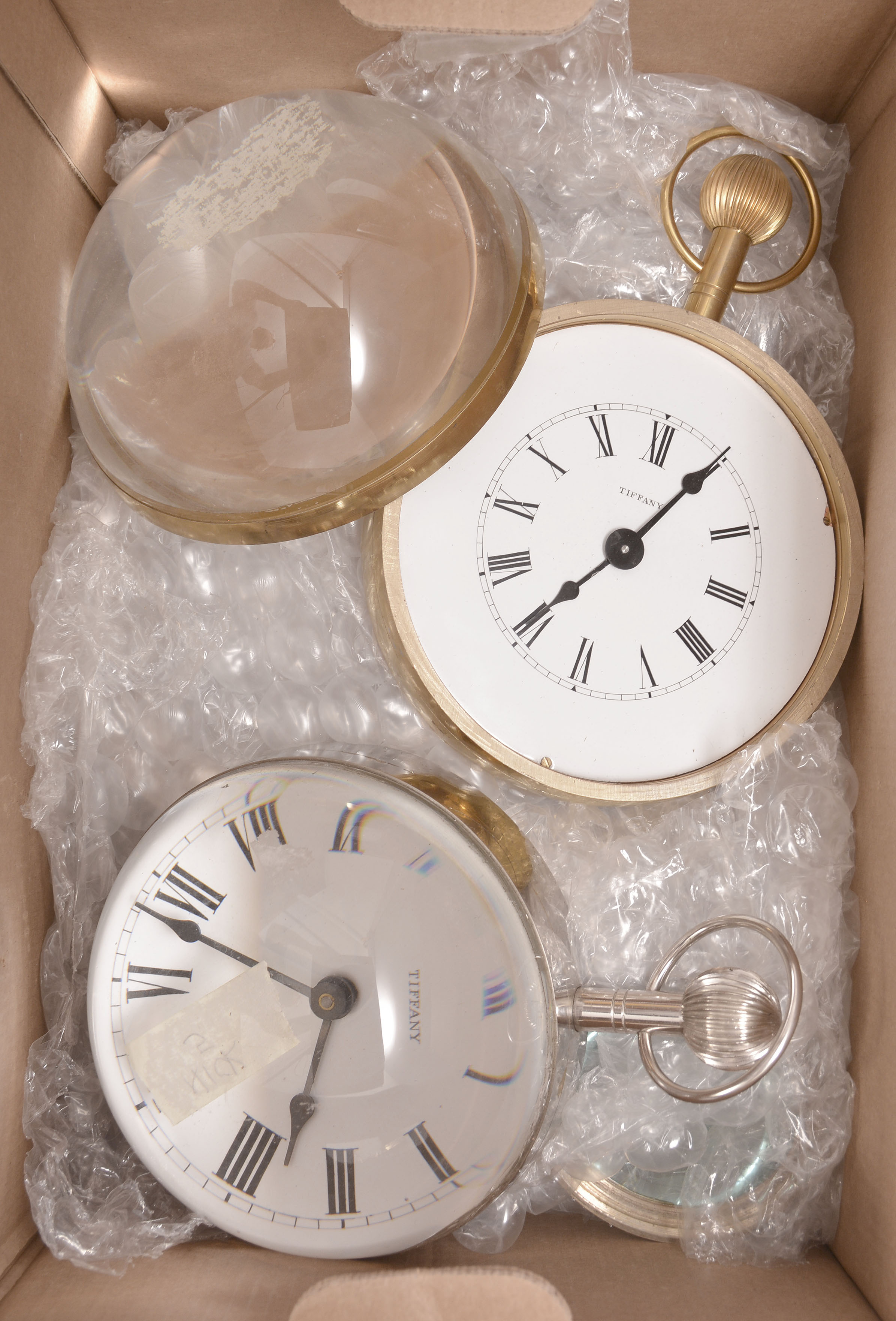 Clocks- 5 (Five): glass paperweight timepieces, 8 day, spring driven balance wheel car clock movements by Waltham, Elgin, and others in brass cases crown, pendant, and bows, covered with magnifying glass hemispheres, most with white enamel dials, some with black steel hands. — Antique Clocks Price Guide