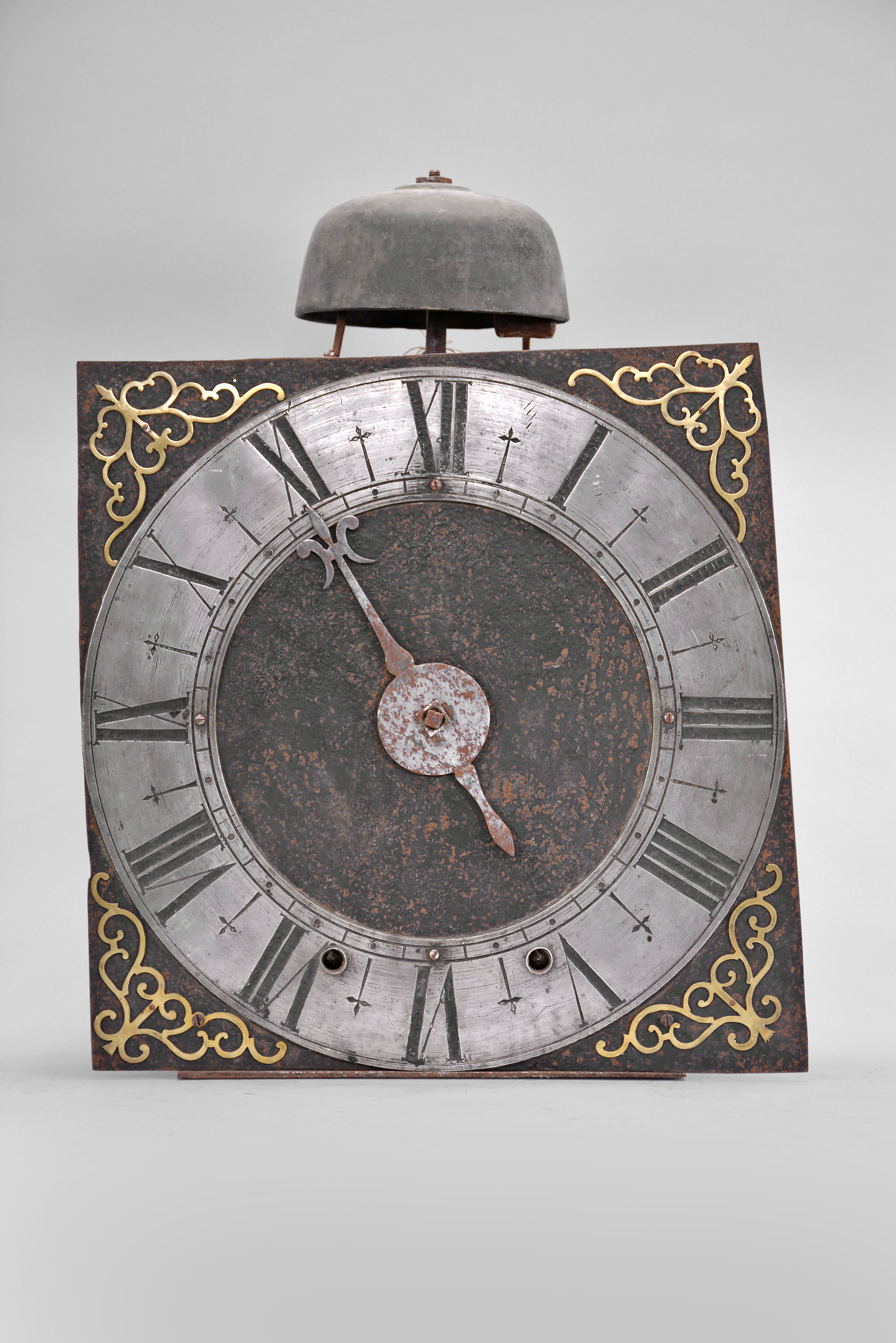 France, oversize Comtoise clock, 8 day, time and strike, weight driven movement with verge escapement, thread suspension with rear-hanging pendulum in an iron post and plate frame, 14 inch pewter chapter ring with Roman numerals, pierced brass spandrels, single iron hand in the form of a fleur de lis. — Antique Clocks Price Guide