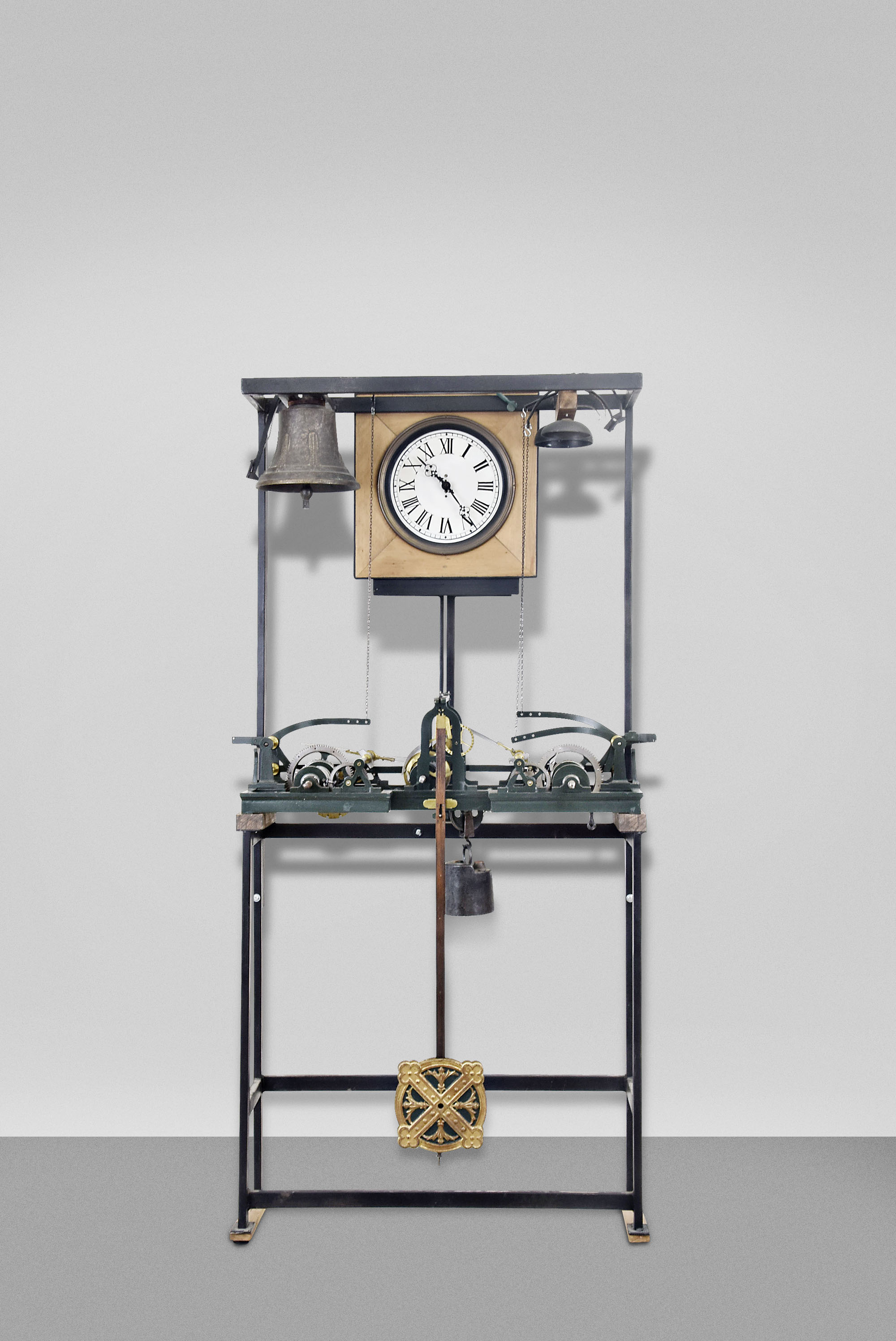 Europe, tower clock, time, strike and chime, three train movement with pinwheel escapement in a green painted cast iron frame with decorative pendulum bob now arranged in a custom stand and frame with bells and dial to operate in a standard room. Nameplate attached to frame is engraved "PAUL GARNIER Horloger Mecanicien 6&17 Rue Taitbour Paris ". — Antique Clocks Price Guide