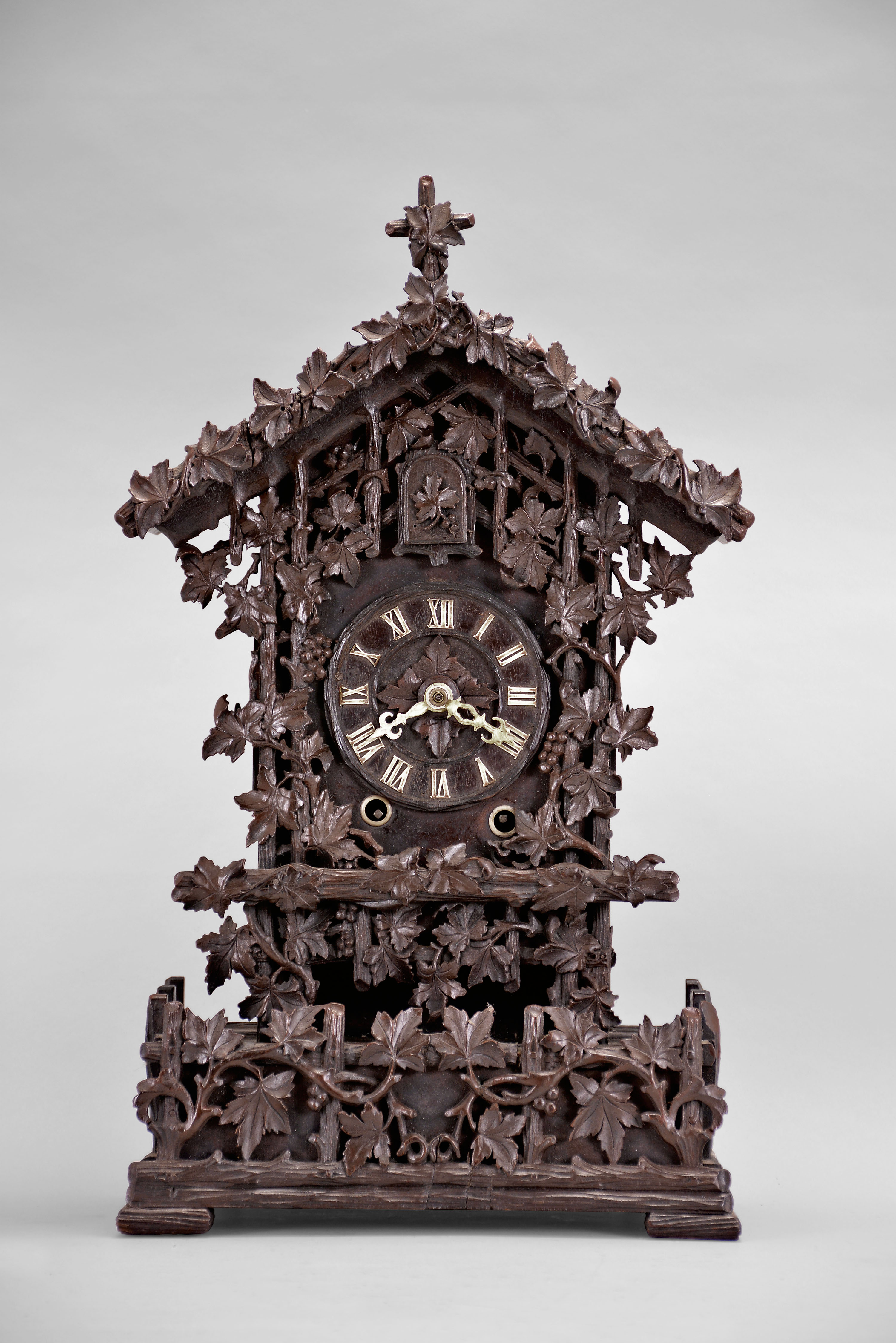 Attributed to Johann Baptiste Beha, Eisenbach, Germany, "No. 508" model shelf cuckoo, 50 hour, time and strike with calling cuckoo bird, spring driven movement in an elaborately carved case replete with foliate, vine, and fence decorations. The wooden dial with Roman numerals and white hands, all on a matching carved wall bracket. See Justin Miller's book, Appendix A, Beha Catalog 1895-1900, page 7, No. 508. — Antique Clocks Price Guide