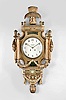 Lenzkirch AG, Lenzkirch, Germany, for the Swedish market, cartel clock, 8 day, time and strike, spring driven pendulum movement in a grand gilt wood case adorned with garlands, swags, fluted pilasters and sheaf of wheat finial, painted metal dial with Arabic numerals signed by a Swedish retailer, and gilt hands.