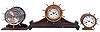 Clocks- 6 (Six) Marine and wall Clocks: most by Waterbury Clock Co. including their "Ship's Bell No. 11" on wood stand, c1915; a ship's bell in the form a yacht wheel in a nickel case on wood stand, 8 inch, c1929, an "Octagonal Lever" with simple calendar, c1909, clock portion of marine-themed desk set, c.1910 and a small octagon and a round 30 hour marine clocks with wood cases, c1900.
