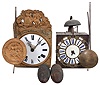 Clocks- 2 (Two) Morbier: France, morbier wall clocks, 8 day, time and strike, weight-driven, posted frame movements with verge escapements, one with a white enamel dial and the other with cartouche numerals, two folding pendulums, and one set of weights