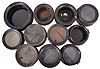 18 (Eighteen) Marine Clock Cases: black painted wood and brass, black phenolic, and nickel-plated brass marine clock cases by various makers in assorted sizes. A number of nickel plated wall mounting plates are also included.