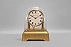 Eureka Clock Co., London, battery powered mantel clock with oversized balance wheel movement on a brass base and a cream color porcelain dial, s#2550