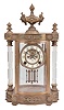 Reproduction Ansonia Clock Co., "Jupiter" crystal regulator, 8 day, time and strike, spring driven movement with visible Brocot escapement in a glazed brass case flanked by cut glass columns, two-piece white porcelain dial with blued steel hands, all surmounted by an urn finial.