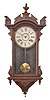 Clocks- 2 (Two): (1) E. N. Welch, Forestville, Conn., wall clock, 8 day, time only, spring driven movement in an ash case with walnut burl accent and painted metal dial, c1890; (2) E. N. Welch, Forestville, Conn., wall clock, 8 day, time and strike, spring driven movement in a walnut case with carved elements, c1880.