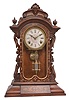 Ansonia Clock Co., New York, "Fifth Avenue", 8 day, time and strike, spring driven movement in a walnut and walnut burl veneer case with carved elements.
