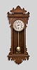Ansonia Clock Co., New York, for Metropolitan Manufacturing Co., "Eclipse" hanging gingerbread clock, 8 day, time and simple calendar, spring driven movement in an oak case.