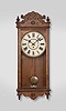Waterbury Clock Co., Waterbury, Conn., "Fostoria" wall clock, 8 day, time only, spring driven movement in an oak case with 12 inch painted metal dial.