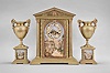 France, three piece mantel garniture set, 8 day, time and strike, spring driven pendule de Paris movement in a metal case of classic architectural form with stepped base, six full Corinthian columns flanking an ashlar facade with central arch, a painted ceramic panel within displaying a gilt chapter ring with Roman numerals, a scene of royals walking amidst an ancient city below the dial, all topped by a pediment with applied gilt ornament, two matching urns, both with painted ceramic panels.