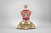 France, ceramic and ormolu mantel clock, 8 day, time and strike, spring driven pendule de Paris movement in a vibrant porcelain vase-form case mounted on a gilt metal base with floral swag, flanked by horned rams, and topped with an urn finial, polychrome painted dial with putto, gilt hands.