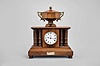Automatic Memorandum Clock Co., London, "Davidson's Patent Automatic Memorandum Clock", 8 day time and reminder, spring driven balance wheel movement in a walnut case with four full pillars and wooden urn on top, white enamel dial and blued steel hands.