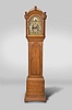 Timothy Cheney, Hartford, Conn., tall clock, 30 hour, time and strike, weight driven wooden movement in a pine case with arched top with reeded columns flanking hood door over a tombstone door on trunk resting on a cove molded and block feet. The brass dial is laid on wood and has a silvered chapter ring, calendar aperture, seconds bit and cast brass spandrels with Timothy Cheney signature in boss on arch.