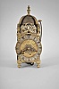 Peter Closon, London, a mid 17th century miniature striking lantern clock, the brass case with turned, tapered columns at the corners, with ball feet and urn finials, three sides with engraved, dolphin frets, and top with brass bell strap with finial and bell, dial plate with engraved tulips, and signed "Peter Closon Neere Holburn Bridge Londini Fecit", silvered brass chapter ring with roman numerals and matchstick flower half hour markers and blued steel hands, movement with crown wheel escapement and count wheel striking, contrate and crown wheels without crossings, with 20th century wall bracket