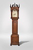 Jacob Guthart, Lebanon, Penn., tall clock, 8 day, time and strike, weight driven movement in a handsome cherry case with broken arch pediment set with concentric turned rosettes, three wooden finials, full columns flanking hood, shaped trunk door flanked by fluted quarter columns over base with matching quarter columns and recessed panel on bracket feet with cutout skirt. The painted metal is signed by maker and has moon phase, calendar and seconds bit. The dial was made and signed by "NOLEN'S MANUFACTY BOSTON ".