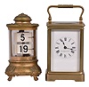Clocks- 2 (Two): (1) Ansonia Clock Co., New York, "Design No. 4" Plato timepiece, 30 hour, time only, spring driven balance wheel movement in a cylindrical brass and glass case with digital flip-card time display, c1907; (2) Boston Clock Co., Boston, Mass. for Bailey Banks, & Biddle, carriage clock, 8 day, time and strike, tandem-wind spring driven balance wheel movement in a glazed brass case, c1890.