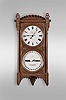 Seth Thomas Clock Co., Thomaston, Conn., "Office Calendar No. 5" wall clock, 8 day, weight driven movement with perpetual calendar in a walnut case with six burl spandrels on front door and lenticle for pendulum bob and painted metal dials