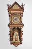 Ansonia Clock Co., New York, "Antique Hanging" wall clock, 8 day, time and strike, weight driven brass movement in a mahogany case with cast brass appliques, embossed pendulum bob and dial pan with turned weights