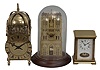 Clocks- 3 (Three): (1) All British Escapement Co., London, lantern clock reproduction, 8 day, time only, spring driven balance wheel movement with lever escapement in a brass case, c1940; (2) Hermle, Gosheim, Germany, skeleton style clock, 8 day, time and passing strike, spring driven movement in a pierced brass case under a glass dome, c1989 (3) W.& A. Schmid,Schwenningen, Germany, carriage style clock, 8 day, time and strike, spring driven pendulum movement in a brass and glass case, c1985.