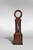 Howard & Davis, Boston, Mass., a rare astronomical standing regulator, walnut, rosewood and rosewood veneer drumhead case, the base with turned, quarter round bead moldings framing recessed panels at the front and sides, and finished with a deep cavetto molding transitioning to the trunk, the trunk door with arched, crossbanded opening for viewing the weight and pendulum, and flanked by two narrow faux panels with crossbanded surround, the case sides also with glazed, arched windows, and surmounted by a cavetto molding below an incurved transition piece with conforming, molded panel, and supporting the drumhead with turned, molded door before the silvered brass dial, signed "Gifford, Estes & Co.", and "Howard & Davis Manufacturers, Boston", blued steel hands, large 8 day, weight driven timepiece movement with brass counterpoise for minute hand, jewelled pallets, pallet arbor, and escape wheel, and having adjustable steel endpieces throughout, brass weight with lyre form pulley, mercury pendulum with steel rod and decorative steel components, and blue cased glass jar with elongated, oblong clear cut panels, and with silvered beat scale, all before a mirrored case back, catching and reflecting light, and enhancing the decorative aspects of the various components