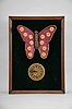 The Attracto Company, Philadelphia, Penn., jeweler's advertising display, spring driven pendulum movement in a wood case powering a velvet covered butterfly with moving wings, 12 finger ring holders on the wings corresponding to the birthstone for each month.