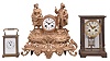 Clocks- 3 (Three) French: (1) France, carriage clock, 8 day, time and strike, spring driven movement with lever escapement in a glazed Corniche style case, c1900; (2) Japy Freres & Cie, Paris, crystal regulator, 8 day, time and strike, spring driven pendule de Paris movement with compensating pendulum in a glazed brass case with white porcelain dial with garlands, c1910; (3) France, figural mantel clock, 8 day, time and strike, spring driven pendule de Paris movement in an ormolu case depicting a farming couple, white enamel dial with blued steel hands, c1880; Also included in the lot are four crystal regulator cases, one with movement.