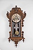 Wm. L. Gilbert Clock Co., Winsted, Conn., "Columbia" wall hanging clock with a spring driven 8 day time and strike (cathedral gong) movement in a walnut case.