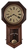 Clocks- 2 (Two): (1) Ansonia Clock Co., New York, "Regulator A" wall clock with a spring driven 8 day time and half hour strike in a black walnut case. c1895. (2) Ansonia Clock Co., New York, "Office Regulator" wall clock with a spring driven 8 day time and half hour strike with seconds bit in a black walnut case. c1895.