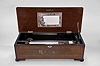 Switzerland, music box, playing 10 tunes with a 11 inch cylinder on a comb with 62 teeth in a grain painted wood case having a rosewood top with tinted inlay with musical trophy motif.