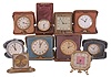 Desk and travel clocks- 10 (Ten), 30 hour and 8 day, Swiss and American, makers including Waltham, New Haven, Waterbury, Keinzle, Normis, and others, most with folding, leather bound cases, one desk clock with octagonal case, easel back, and pink mother of toilet seat center, an unusual Waterbury travel clock with wooden case, and more