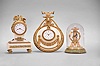 Clocks- 3 (Three) Charles Hour, Paris: (1) Miniature skeleton clock, 8 day, time only, spring driven movement with lever escapement on a green onyx base, under a small glass dome, c1910; (2) Desk clock, 8 day, time only, with jeweled balance wheel movement in a cast brass and white marble case surmounted by a pair of birds, c1900; (3) Desk clock, 8 day, time only, jeweled spring driven movement in a white marble case with applied metal ornaments and topped by goat's head, c1900.