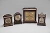 Clocks- 4 (Four) Japanned desk clocks, 8 day, time only, spring driven movements: (1) Elliott, London, desk clock with a square case with molded top and base; (2) Elliott, London, miniature bracket clock, black case with gold trim; (3) Samuel Marti for J.E. Caldwell, Philadelphia, miniature bracket clock with guilloche silvered dial. (4) Canham, London, miniature bracket clock with engraved silvered dial.