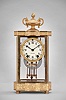 Seth Thomas Clock Co., Thomaston, Conn., "Empire No. 7" crystal regulator, 8 day, time and strike, spring driven movement in a glazed gilt brass case with urn finial, cream porcelain dial and blued steel hands.